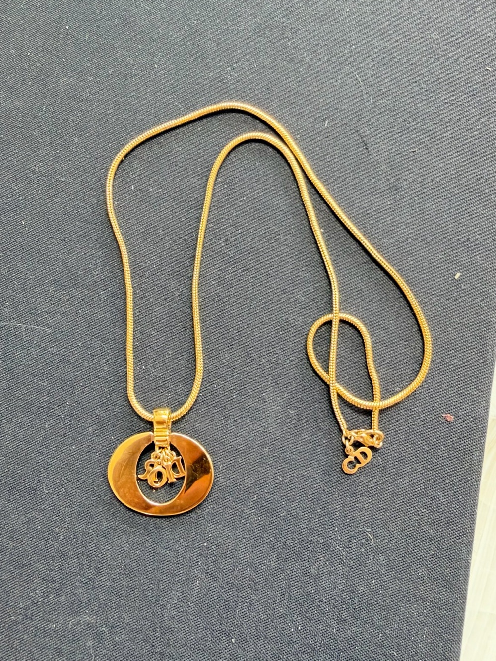 Vintage Christian Dior Gold-Tone Circular Pendant Necklace with Logo Charm